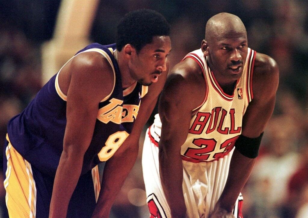 Los Angeles Lakers guard Kobe Bryant(L) and Chicago Bulls guard Michael Jordan(R) talk during a free-throw attempt during the fourth quarter 17 December at the United Center in Chicago. Bryant, who is 19 and bypassed college basketball to play in the NBA, scored a team-high 33 points off the bench, and Jordan scored a team-high 36 points. The Bulls defeated the Lakers 104-83. AFP PHOTO VINCENT LAFORET (Photo by VINCENT LAFORET / AFP) (Photo credit should read VINCENT LAFORET/AFP/Getty Images)