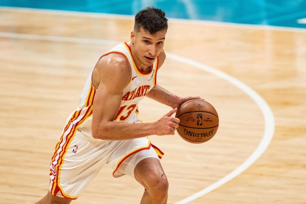 CHARLOTTE, NORTH CAROLINA - APRIL 11: Bogdan Bogdanovic #13 of the Atlanta Hawks brings the ball up court against the Charlotte Hornets in the first half during their game at Spectrum Center on April 11, 2021 in Charlotte, North Carolina. NOTE TO USER: User expressly acknowledges and agrees that, by downloading and or using this photograph, User is consenting to the terms and conditions of the Getty Images License Agreement. (Photo by Jacob Kupferman/Getty Images)