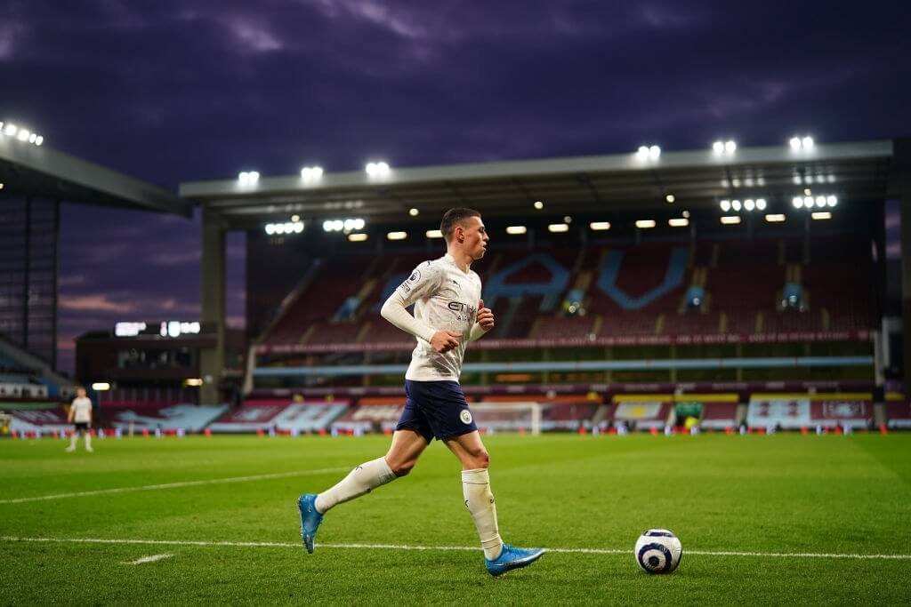 BIRMINGHAM, ENGLAND - APRIL 21: Phil Foden of Manchester City prepares to take a corner during the Premier League match between Aston Villa and Manchester City at Villa Park on April 21, 2021 in Birmingham, England. Sporting stadiums around the UK remain under strict restrictions due to the Coronavirus Pandemic as Government social distancing laws prohibit fans inside venues resulting in games being played behind closed doors.  