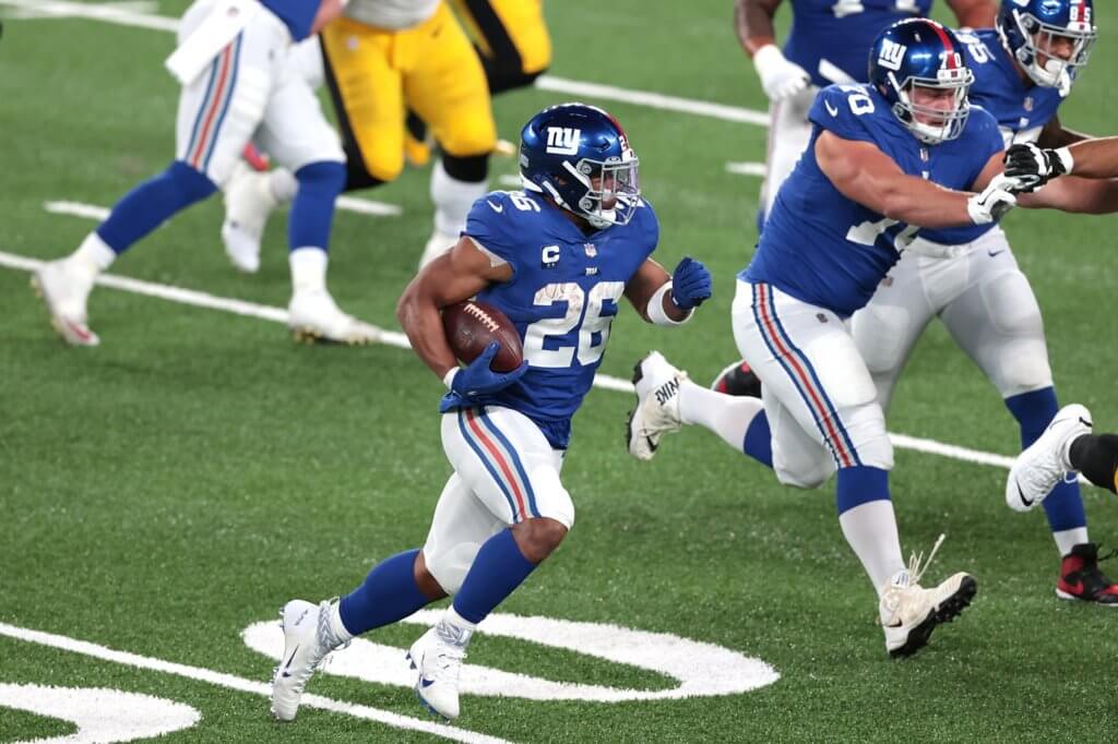 Sep 14, 2020; East Rutherford, New Jersey, USA; New York Giants running back Saquon Barkley (26) carries the ball against the Pittsburgh Steelers as offensive guard Kevin Zeitler (70) blocks during the second half at MetLife Stadium. Mandatory Credit: Vincent Carchietta-USA TODAY Sports

