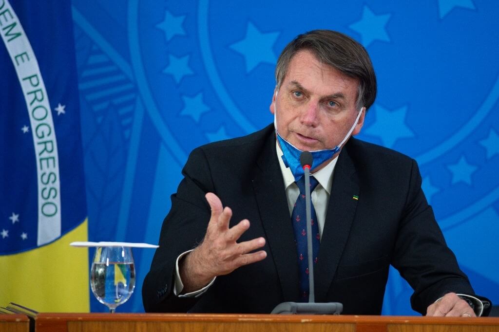 BRASILIA, BRAZIL - MARCH 20: Jair Bolsonaro President of Brazil takes off his protective mask to speak to journalists during a press conference about outbreak of the coronavirus (COVID - 19) at the Planalto Palace on March 20, 2020 in Brasilia, Brazil.