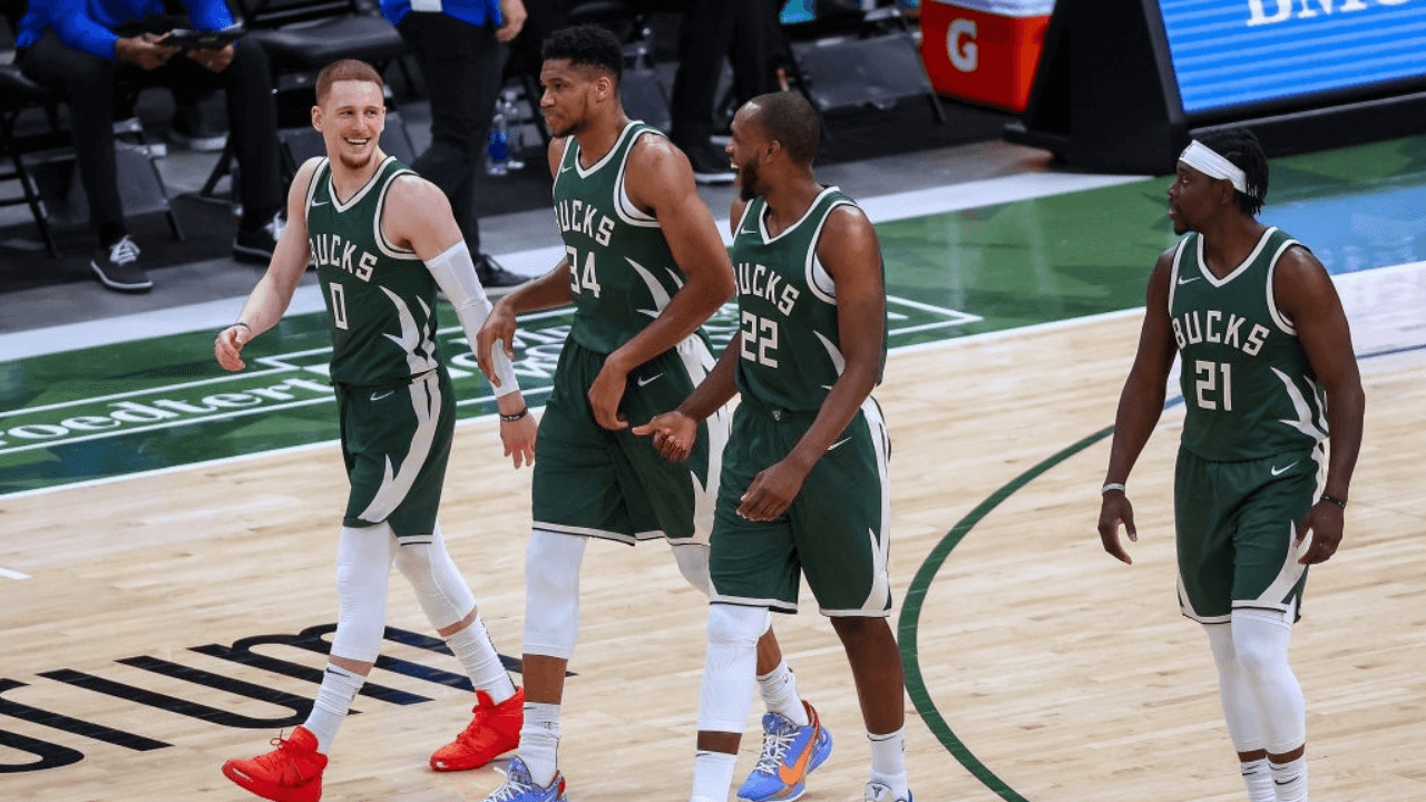 MILWAUKEE, WISCONSIN - MARCH 20: Donte DiVincenzo #0, Giannis Antetokounmpo #34, Khris Middleton #22, and Jrue Holiday #21 of the Milwaukee Bucks walk across the court in the third quarter against the San Antonio Spurs at the Fiserv Forum on March 20, 2021 in Milwaukee, Wisconsin. NOTE TO USER: User expressly acknowledges and agrees that, by downloading and or using this photograph, User is consenting to the terms and conditions of the Getty Images License Agreement. (Photo by Dylan Buell/Getty Images)