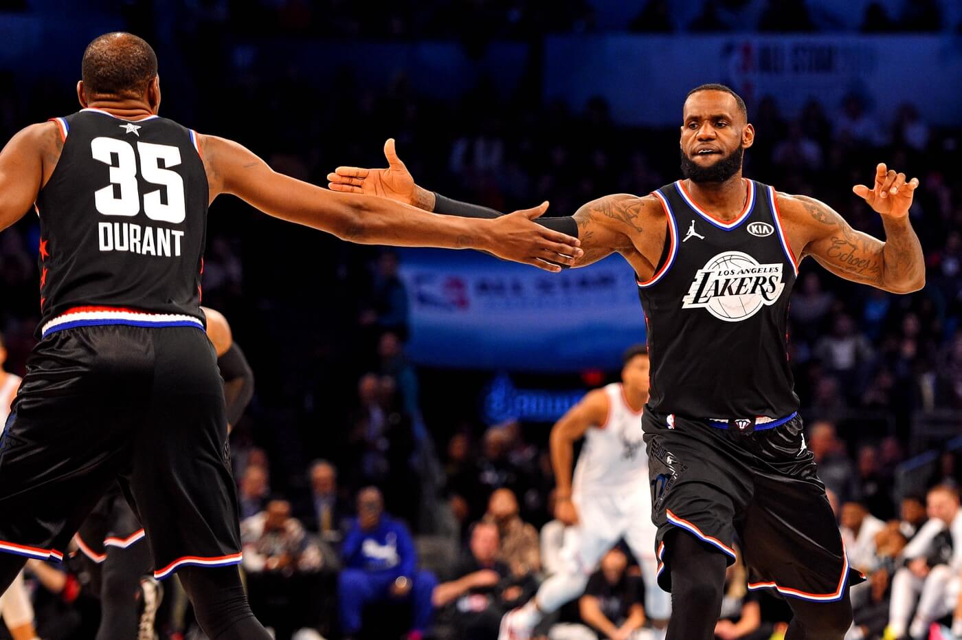 Feb 17, 2019; Charlotte, NC, USA; Team Lebron forward Lebron James of the Los Angeles Lakers (23) reacts with Team Lebron forward Kevin Durant of the Golden State Warrior (35) during the 2019 NBA All-Star Game at Spectrum Center.