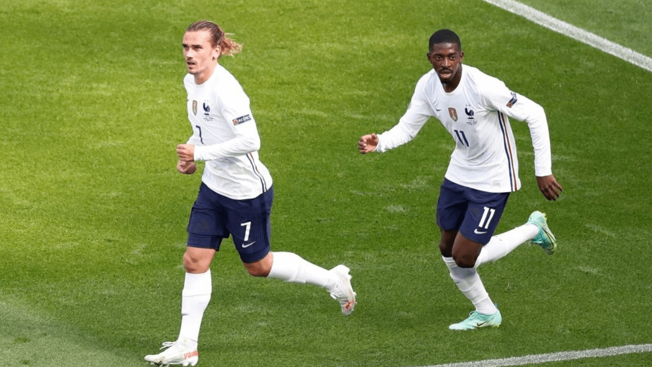 TOPSHOT - France's forward Antoine Griezmann (L) celebrates scoring his team's first goal with his teammate France's forward Ousmane Dembele during the UEFA EURO 2020 Group F football match between Hungary and France at Puskas Arena in Budapest on June 19, 2021. (Photo by Laszlo Balogh / POOL / AFP) (Photo by LASZLO BALOGH/POOL/AFP via Getty Images)