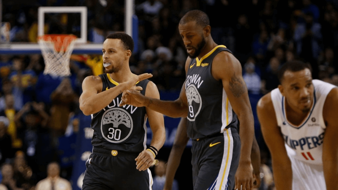OAKLAND, CA - DECEMBER 23: Stephen Curry #30 and Andre Iguodala #9 of the Golden State Warriors celebrate a basket against the LA Clippers at ORACLE Arena on December 23, 2018 in Oakland, California. NOTE TO USER: User expressly acknowledges and agrees that, by downloading and or using this photograph, User is consenting to the terms and conditions of the Getty Images License Agreement. (Photo by Lachlan Cunningham/Getty Images)