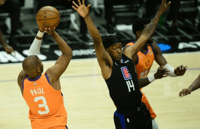 Jun 30, 2021; Los Angeles, California, USA; Phoenix Suns guard Chris Paul (3) shoots a three point basket against Los Angeles Clippers guard Terance Mann (14) during the second half in game six of the Western Conference Finals for the 2021 NBA Playoffs at Staples Center. Mandatory Credit: Gary A. Vasquez-USA TODAY Sports