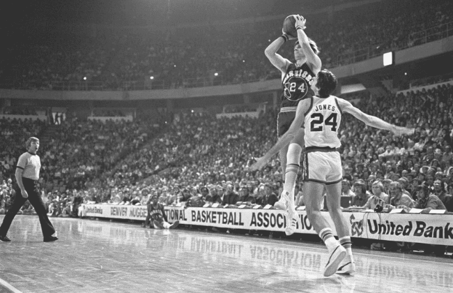 DENVER, CO � NOVEMBER 9: Golden State Warriors forward Rick Barry #24 shoots a jumper from the corner while being defended by Denver Nuggets forward Bobby Jones #24 during an NBA basketball game at McNichols Arena on November 9, 1976 in Denver, Colorado.