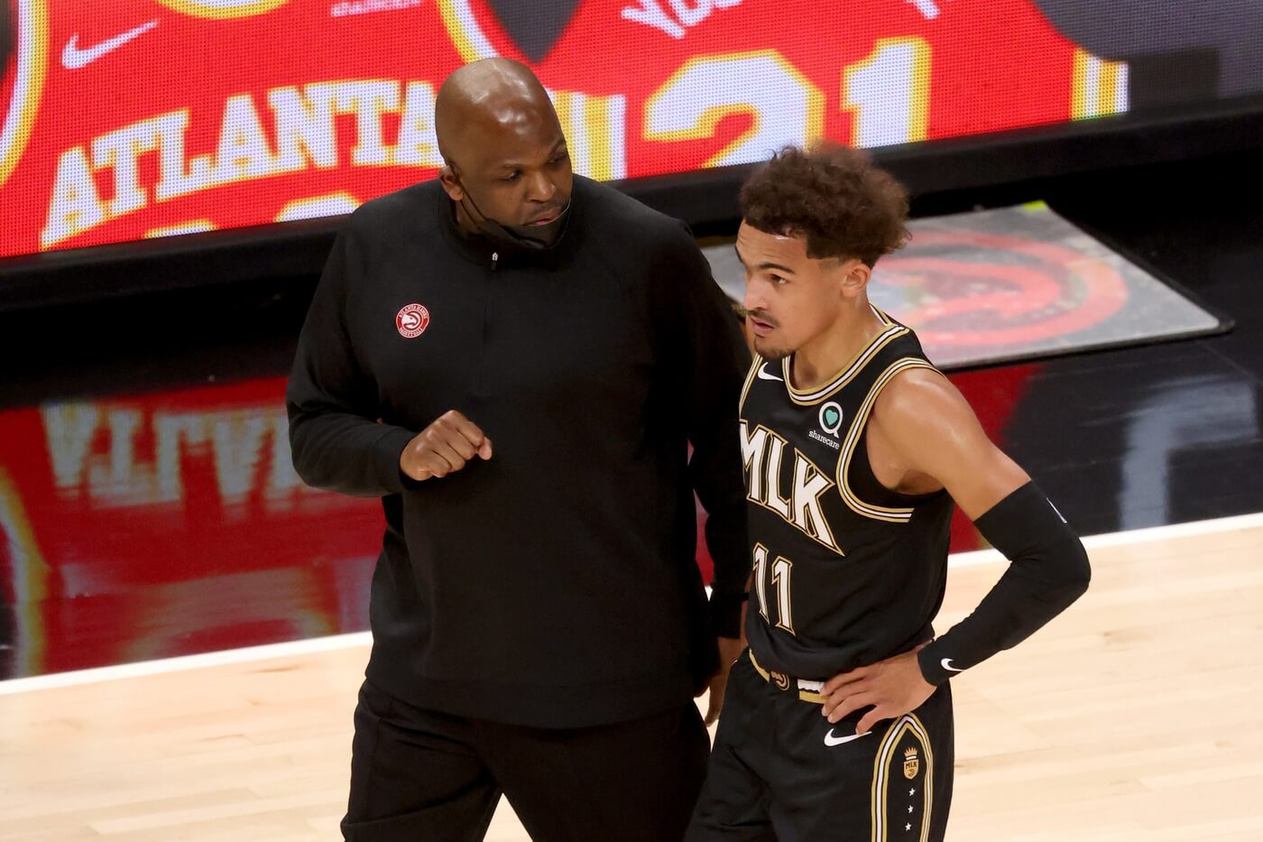 May 5, 2021; Atlanta, Georgia, USA; Atlanta Hawks coach Nate McMillan talks with guard Trae Young (11) during a time out of their game against the Phoenix Suns at State Farm Arena. Mandatory Credit: Jason Getz-USA TODAY Sports