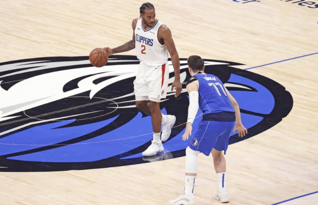 Jun 4, 2021; Dallas, Texas, USA; LA Clippers forward Kawhi Leonard (2) dribbles as Dallas Mavericks guard Luka Doncic (77) defends during the fourth quarter during game six in the first round of the 2021 NBA Playoffs at American Airlines Center. Mandatory Credit: Kevin Jairaj-USA TODAY Sports