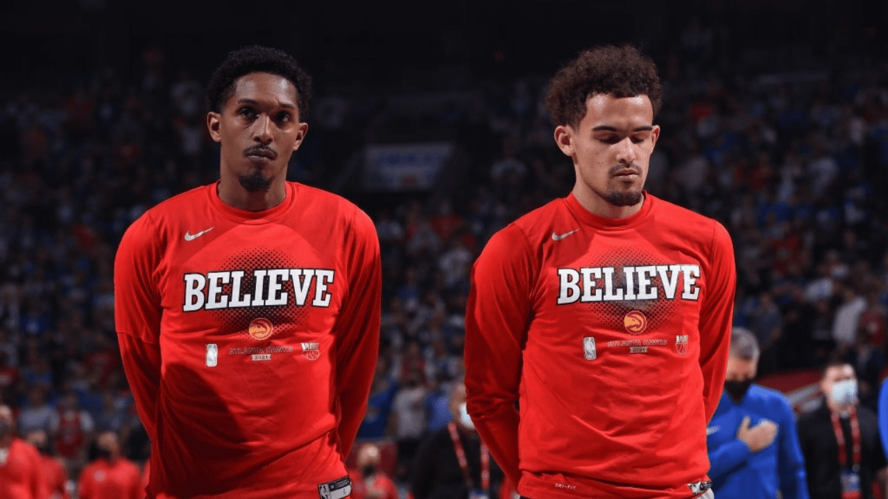 PHILADELPHIA, PA - JUNE 8: Lou Williams #6 of the Atlanta Hawks and Trae Young #11 of the Atlanta Hawks stand for the National Anthem prior to a game against the Philadelphia 76ers during Round 2, Game 2 of the Eastern Conference Playoffs on June 8, 2021 at Wells Fargo Center in Philadelphia, Pennsylvania. NOTE TO USER: User expressly acknowledges and agrees that, by downloading and/or using this Photograph, user is consenting to the terms and conditions of the Getty Images License Agreement. Mandatory Copyright Notice: Copyright 2021 NBAE (Photo by David Dow/NBAE via Getty Images)