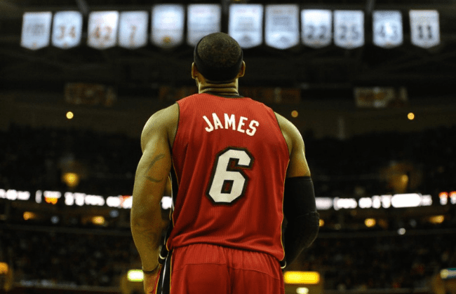 Mar 18, 2014; Cleveland, OH, USA; Miami Heat forward LeBron James (6) stands under the retired jersey numbers of the Cleveland Cavaliers at Quicken Loans Arena. Miami won 100-96. Mandatory Credit: David Richard-USA TODAY Sports