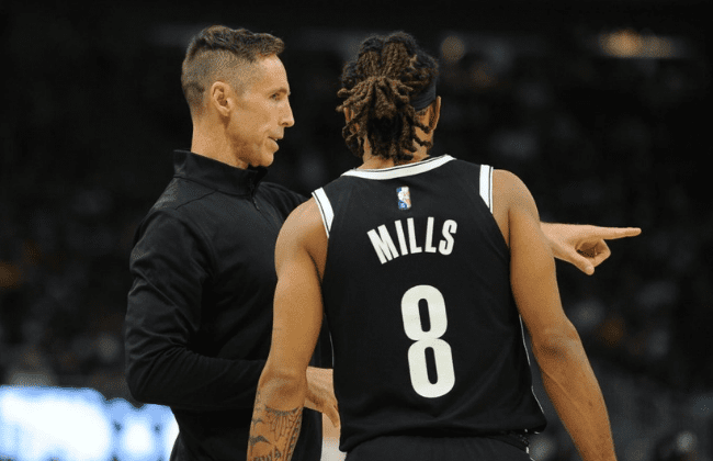 Oct 19, 2021; Milwaukee, Wisconsin, USA; Brooklyn Nets coach Steve Nash talks with Brooklyn Nets guard Patty Mills (8) during a stoppage in play against the Milwaukee Bucks at Fiserv Forum. Mandatory Credit: Michael McLoone-USA TODAY Sports