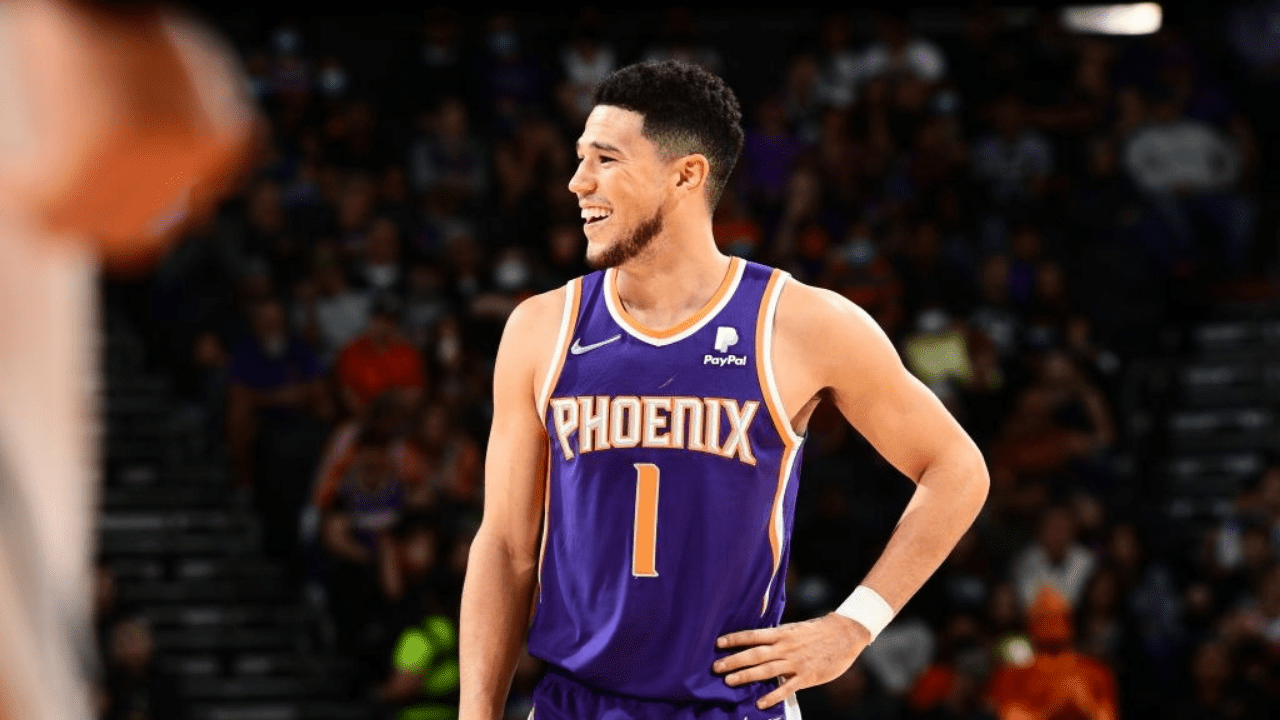 PHOENIX, AZ - NOVEMBER 21: Devin Booker #1 of the Phoenix Suns smiles during the game against the Denver Nuggets on November 21, 2021 at Footprint Center in Phoenix, Arizona. NOTE TO USER: User expressly acknowledges and agrees that, by downloading and or using this photograph, user is consenting to the terms and conditions of the Getty Images License Agreement. Mandatory Copyright Notice: Copyright 2021 NBAE (Photo by Michael Gonzales/NBAE via Getty Images)