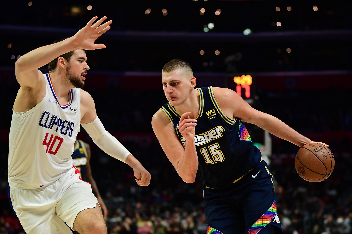Dec 26, 2021; Los Angeles, California, USA; Denver Nuggets center Nikola Jokic (15) moves to the basket against Los Angeles Clippers center Ivica Zubac (40) during the second half at Crypto.com Arena. Mandatory Credit: Gary A. Vasquez-USA TODAY Sports