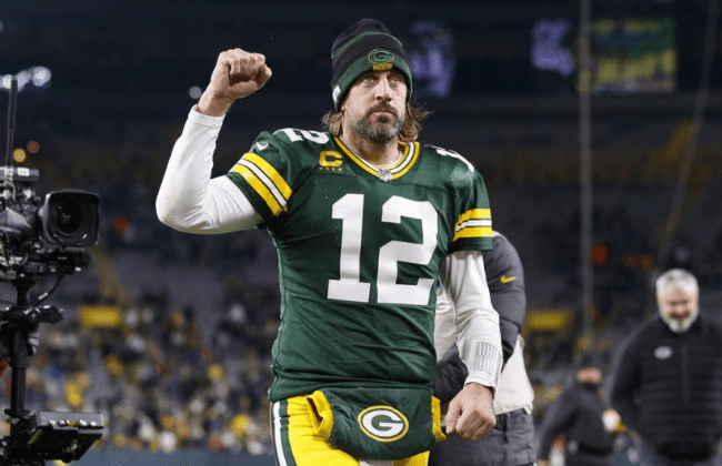 Dec 12, 2021; Green Bay, Wisconsin, USA; Green Bay Packers quarterback Aaron Rodgers (12) celebrates as he walks off the field following the game against the Chicago Bears at Lambeau Field. Mandatory Credit: Jeff Hanisch-USA TODAY Sports
