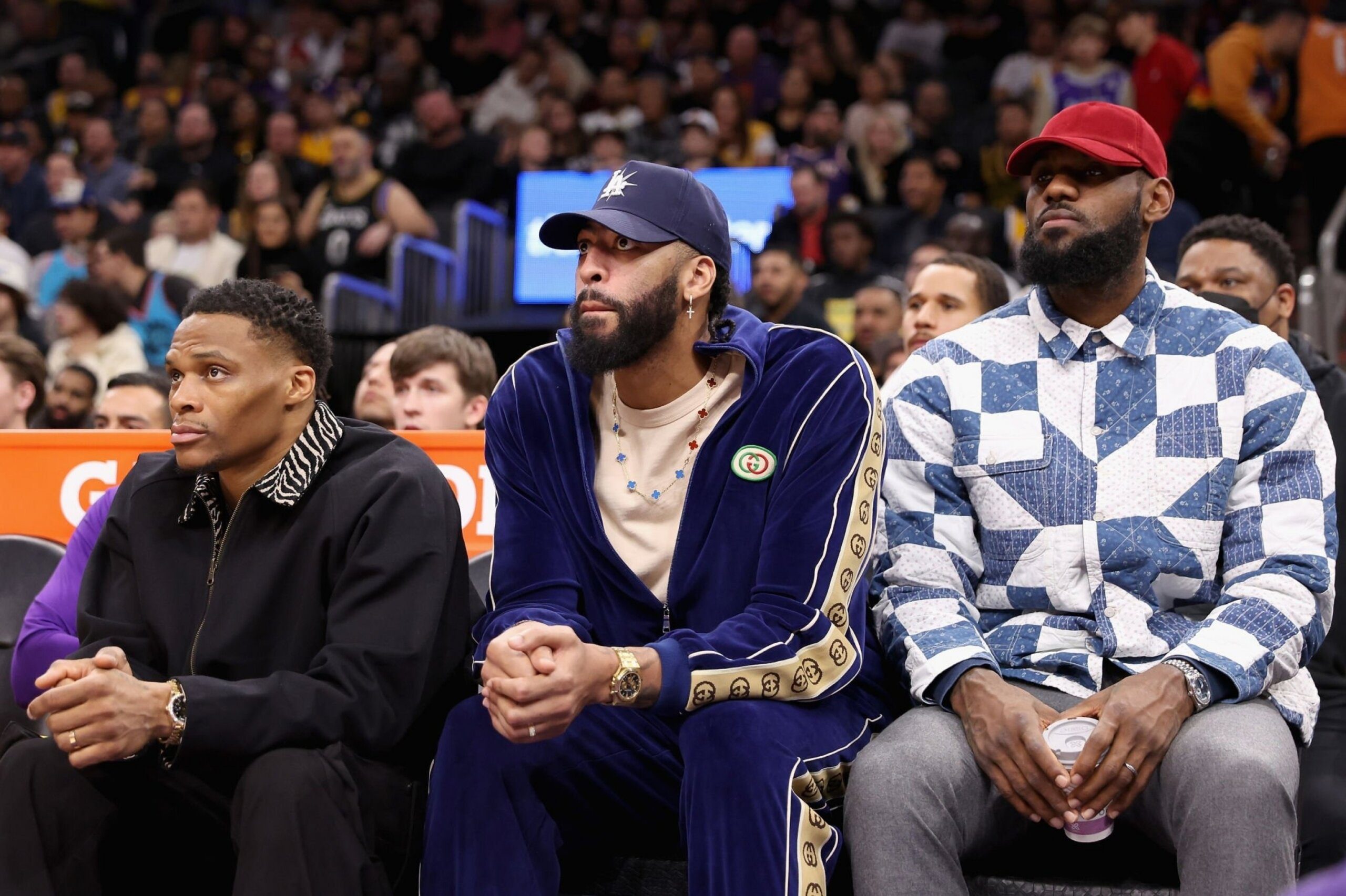 PHOENIX, ARIZONA - DECEMBER 19: Russell Westbrook #0, Anthony Davis #3 and LeBron James #6 of the Los Angeles Lakers watch from the bench during the first half of the NBA game against the Phoenix Suns at Footprint Center on December 19, 2022 in Phoenix, Arizona.