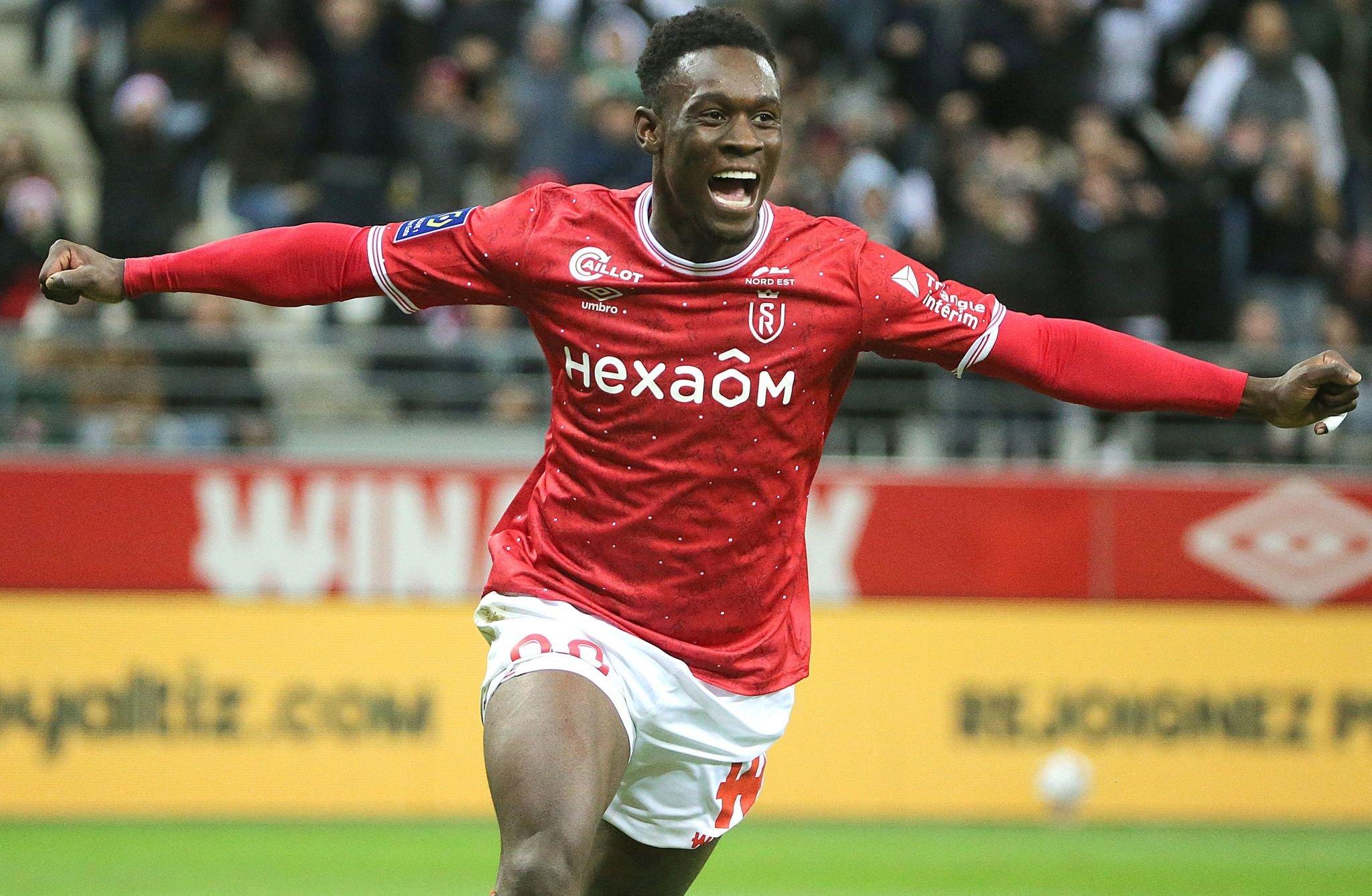 Reims' English forward Folarin Balogun celebrates scoring a goal during the French L1 football match between Stade de Reims and Stade Rennais FC at the Auguste-Delaune II stadium in Reims on December 29, 2022. (Photo by FRANCOIS NASCIMBENI / AFP) (Photo by FRANCOIS NASCIMBENI/AFP via Getty Images)