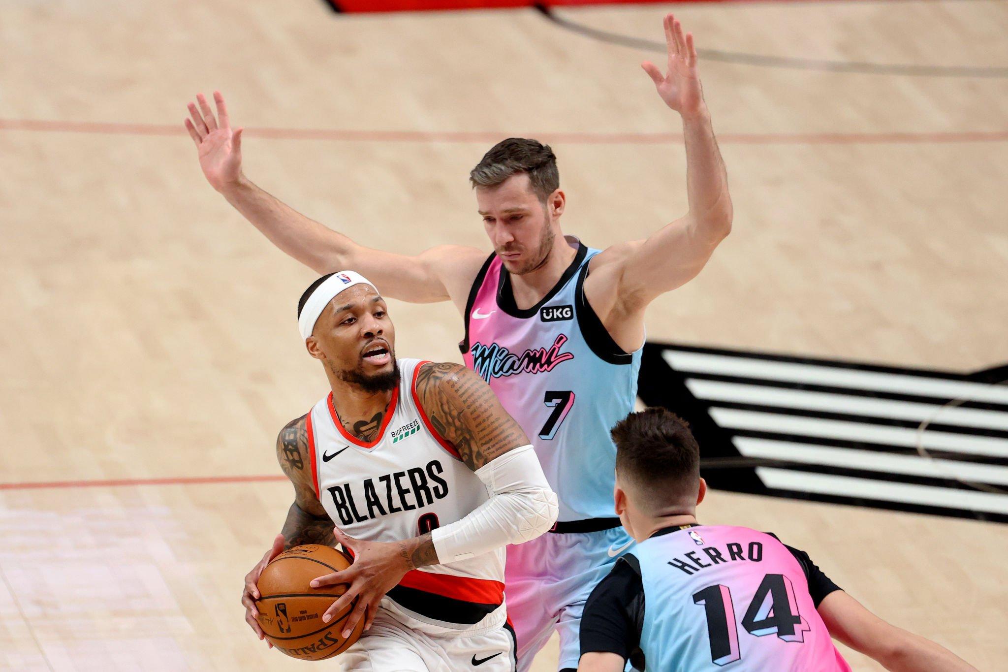 PORTLAND, OREGON - APRIL 11: Damian Lillard #0 of the Portland Trail Blazers works towards the basket against Goran Dragic #7 and Tyler Herro #14 of the Miami Heat in the third quarter at Moda Center on April 11, 2021 in Portland, Oregon. NOTE TO USER: User expressly acknowledges and agrees that, by downloading and or using this photograph, User is consenting to the terms and conditions of the Getty Images License Agreement. (Photo by Abbie Parr/Getty Images)
