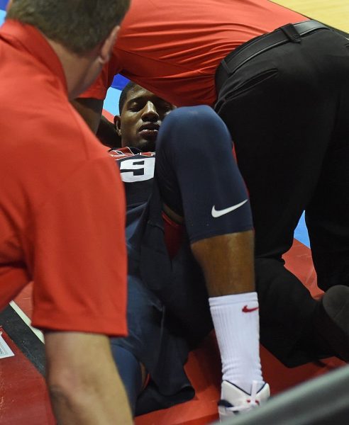 LAS VEGAS, NV - AUGUST 01: Paul George #29 of the 2014 USA Basketball Men's National Team is tended to as he lies on the court after badly injuring his leg defending a play during a USA Basketball showcase at the Thomas & Mack Center on August 1, 2014 in Las Vegas, Nevada. The rest of the exhibition was cancelled after the injury. (Photo by Ethan Miller/Getty Images)