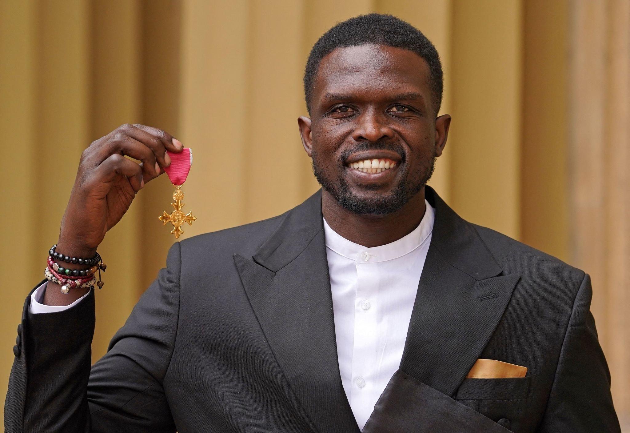South Sudanese-British former professional basketball player Luol Deng poses with his medal after being appointed an Officer of the Order of the British Empire (OBE), at an investiture ceremony at Buckingham Palace in London on July 7, 2022. (Photo by Gareth Fuller / POOL / AFP) (Photo by GARETH FULLER/POOL/AFP via Getty Images)