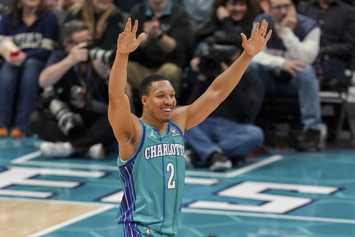 Feb 10, 2024; Charlotte, North Carolina, USA; Charlotte Hornets forward Grant Williams (2) celebrates his three pointer at a time out during the second half against the Memphis Grizzlies at Spectrum Center. Mandatory Credit: Jim Dedmon-USA TODAY Sports
