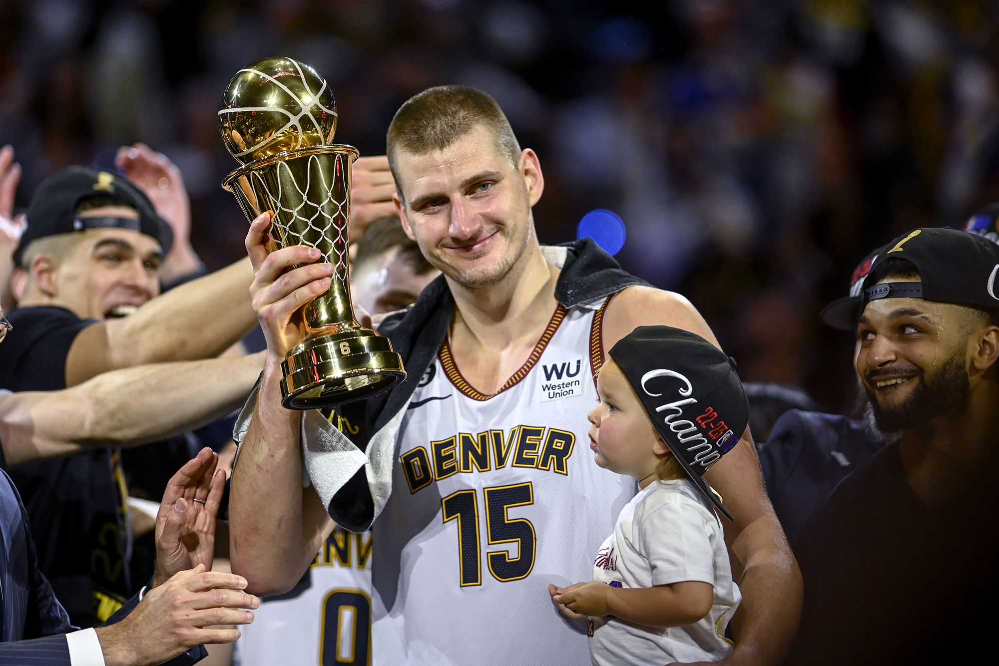 Nikola Jokić, pictured with daughter, Ognjena, celebrates holding the NBA Finals Most Valuable Player Award. AAron Ontiveroz/Denver Post/Getty Images