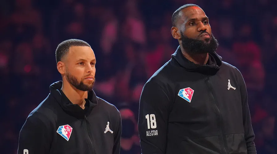 Stephen Curry and LeBron James of Team LeBron are introduced before the 2022 NBA All-Star Game Feb. 20, 2022, at Rocket Mortgage FieldHouse in Cleveland. (Jesse D. Garrabrant/NBAE via Getty Images)